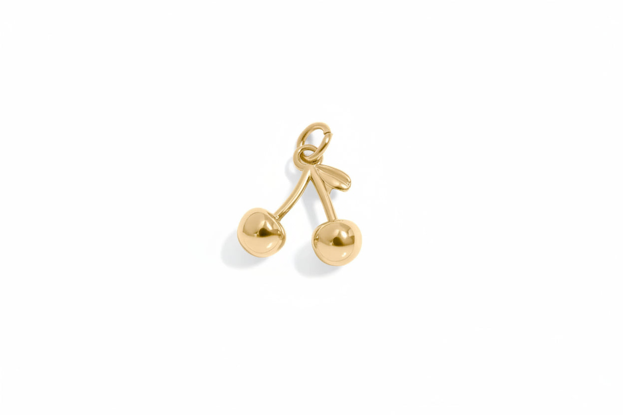 Gold cherry-shaped pendant on a white background