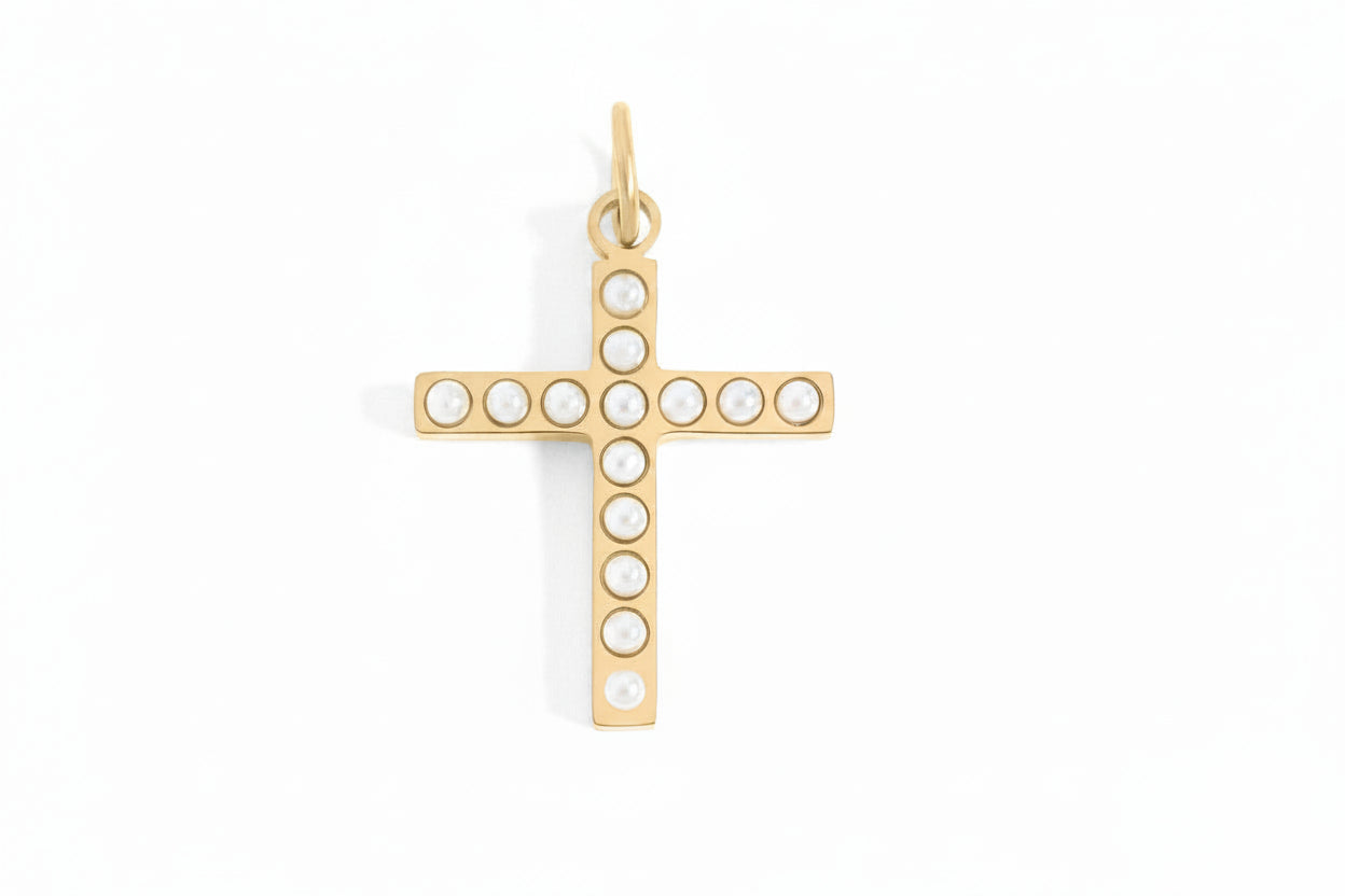 Gold cross pendant with pearls on a white background