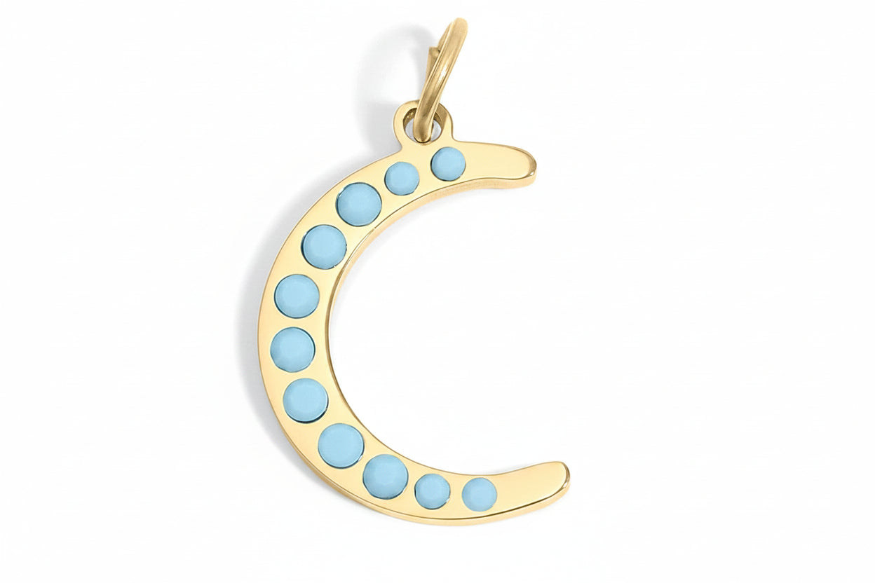 Gold crescent moon pendant with blue stones on a white background