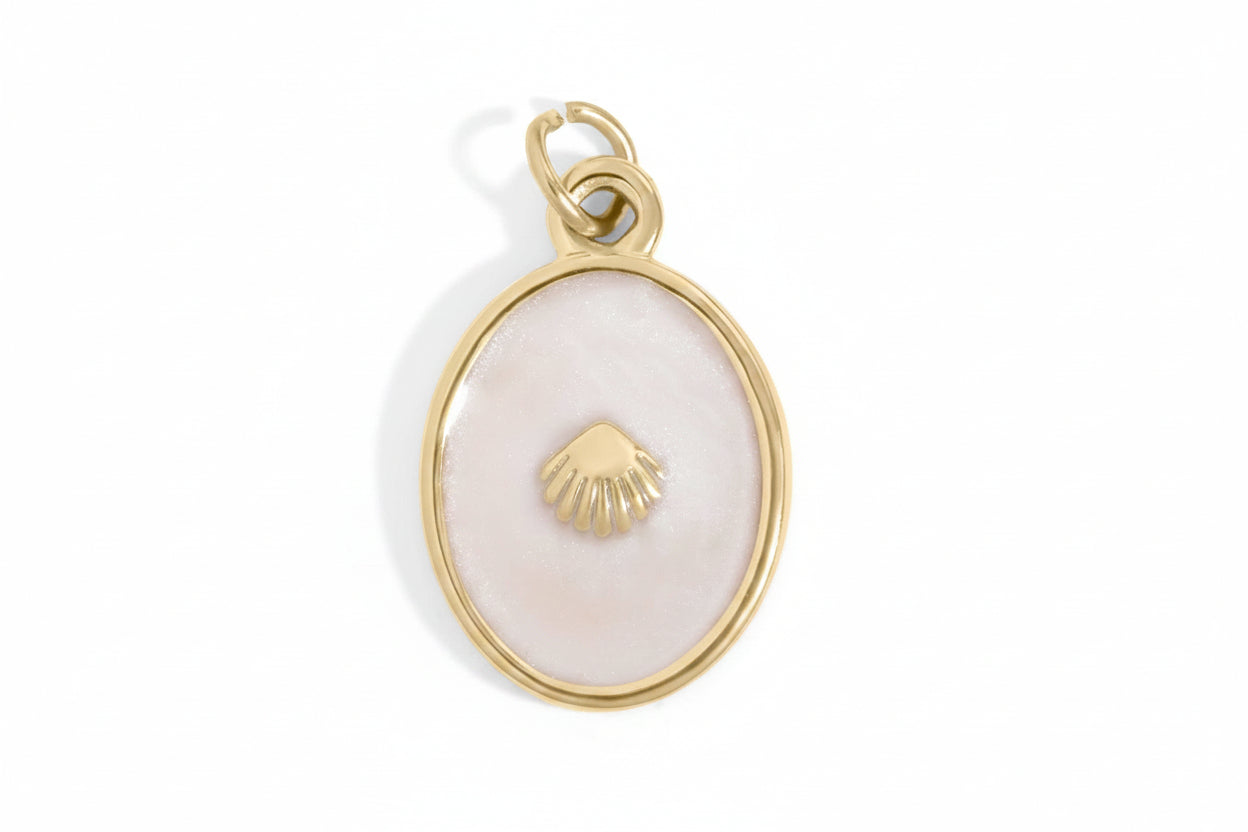 Gold pendant with a shell design on a white background