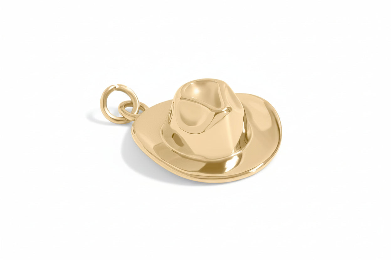 Gold cowboy hat charm on a white background