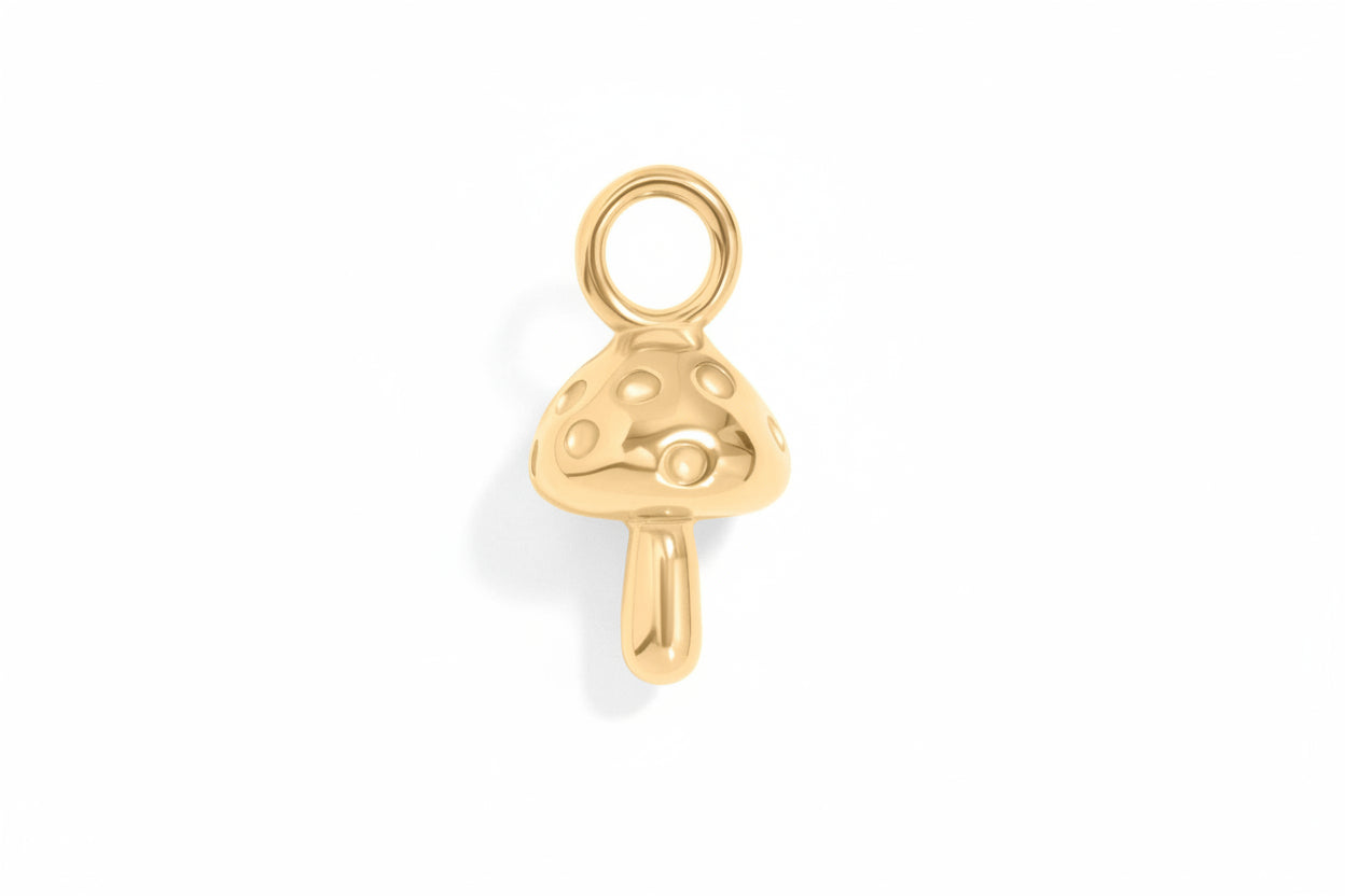 Gold mushroom-shaped charm on a white background