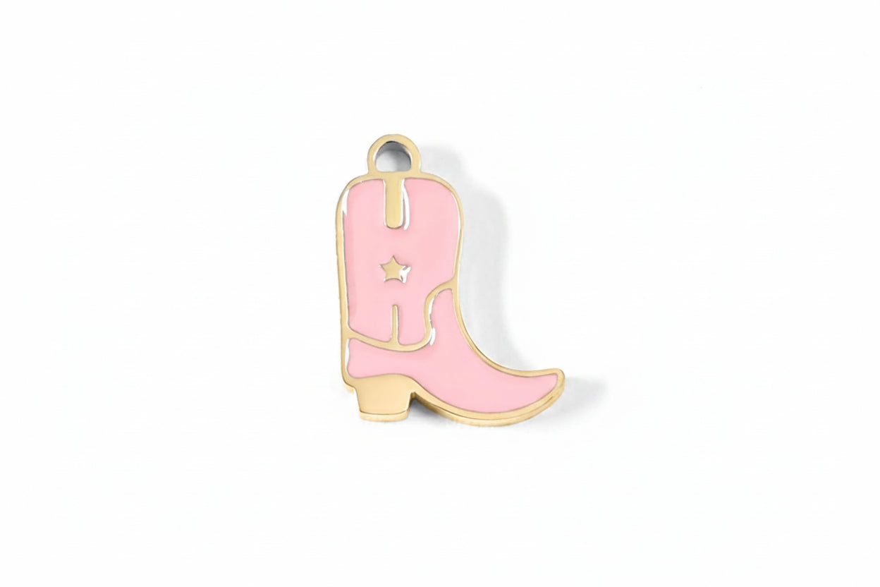 Pink cowboy boot charm on a white background