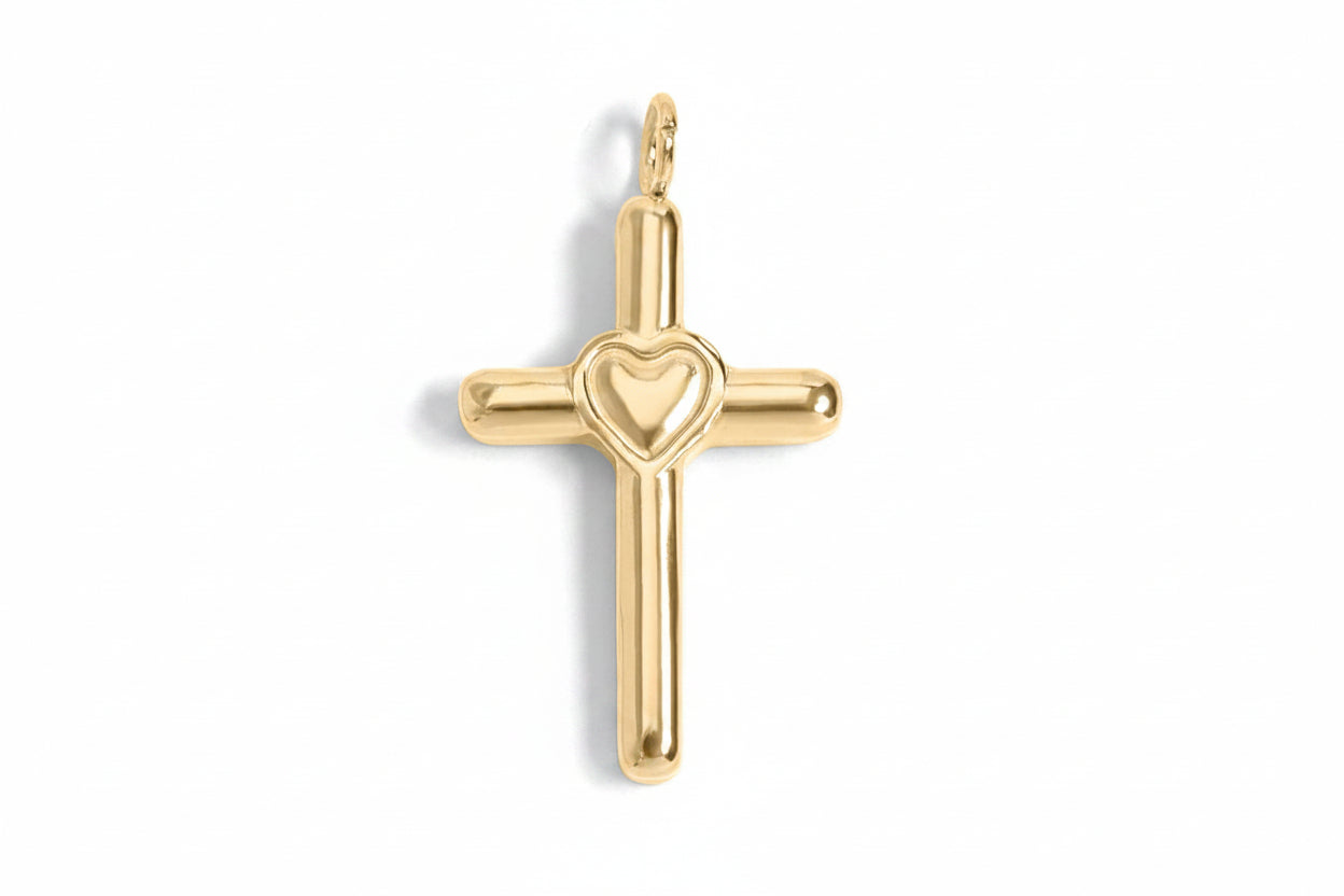 Gold cross pendant with a heart design on a white background
